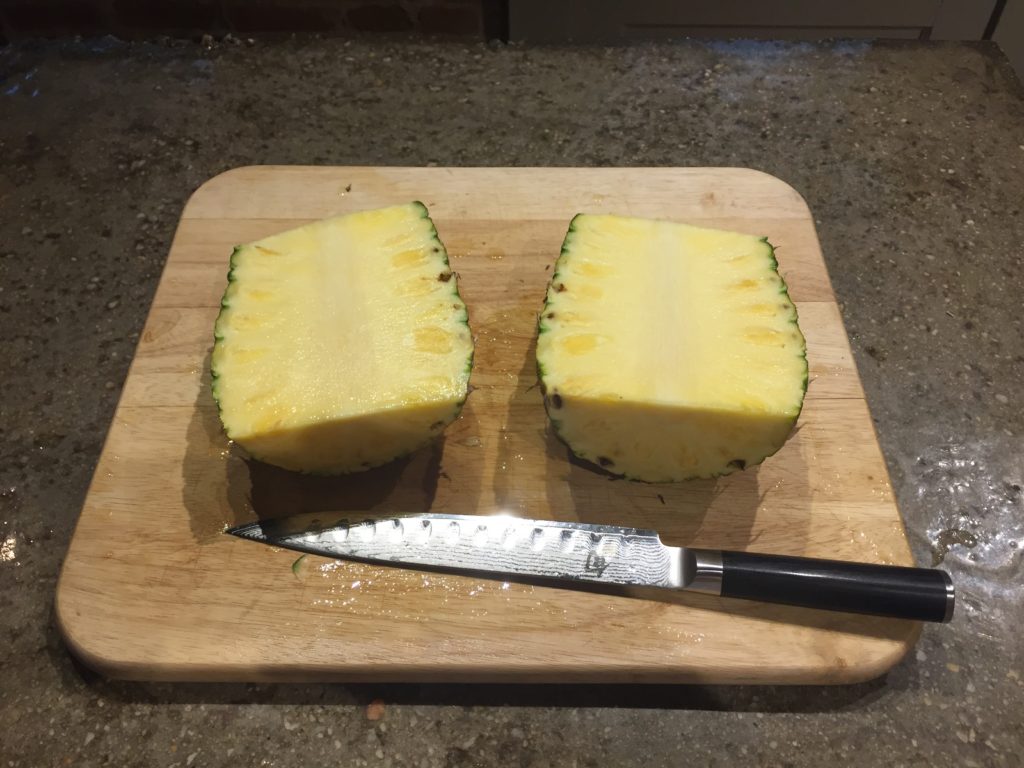 Cut the pineapple in half