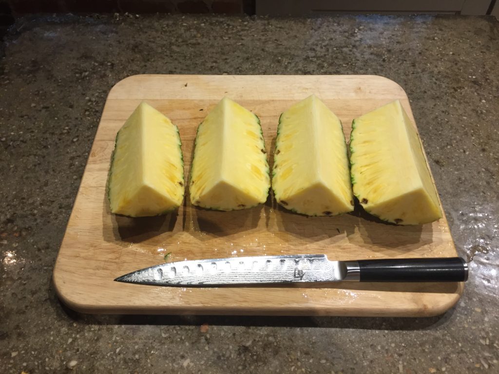 Cut the pineapple into quarters