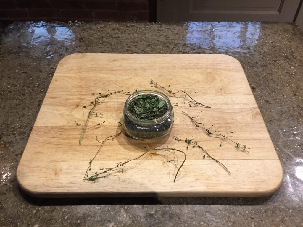 Dried-Oregano-In-A-Jar-With-Garbled-Sprigs